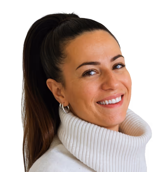 Smiling woman with long dark hair in a high ponytail wearing a white turtleneck sweater and hoop earrings.