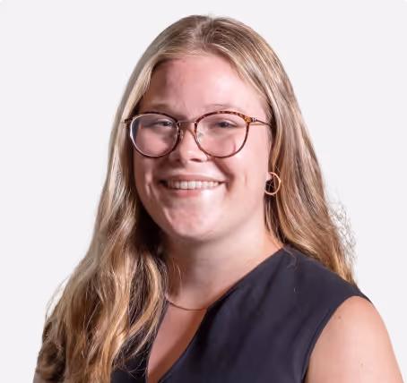 Young man in a tuxedo with a bow tie against a white background.