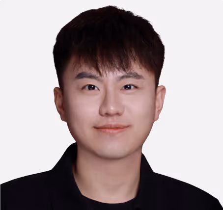 Young man in a tuxedo with a bow tie against a white background.