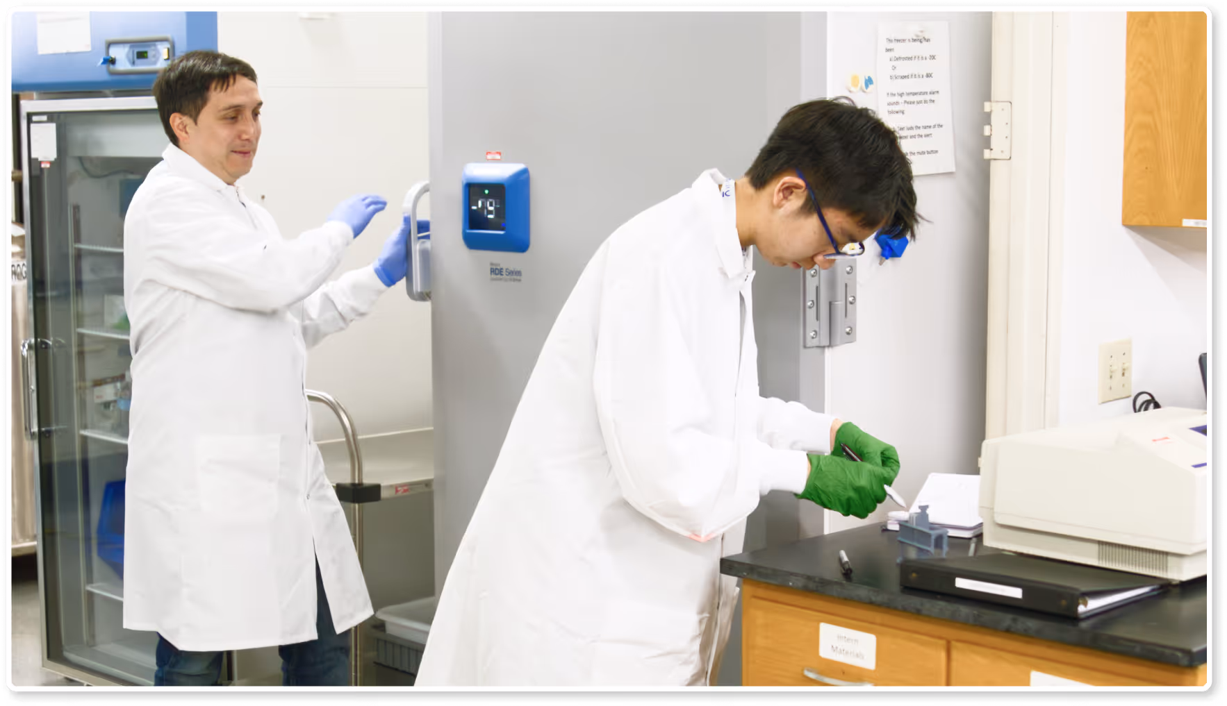 View of the Radcliffe Camera, a historic circular stone library building with a large dome, seen from behind a group of people.