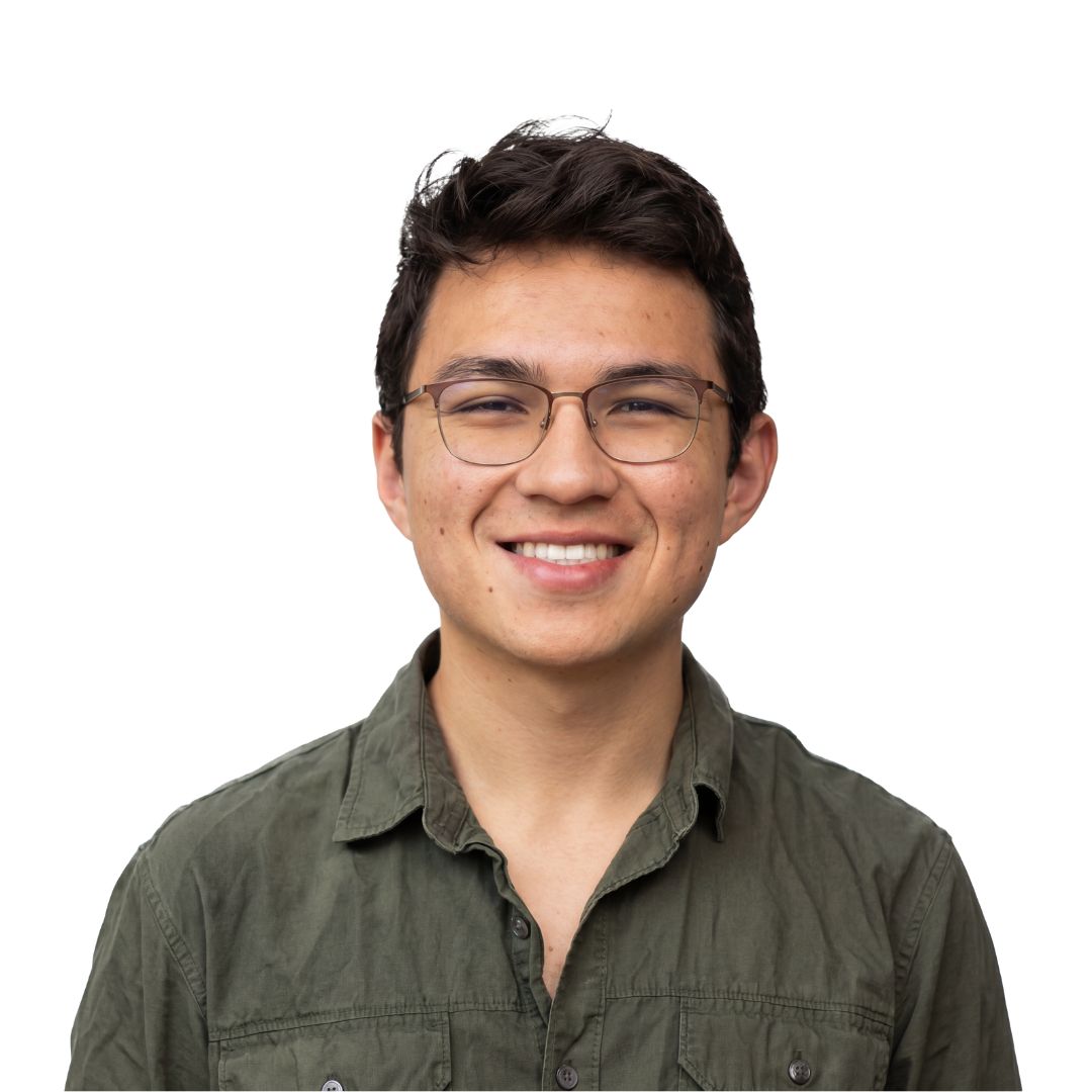 Young man in a tuxedo with a bow tie against a white background.