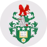 Coat of arms featuring a red lion atop a helmet, green and white shield with a gold square and three gold stars.