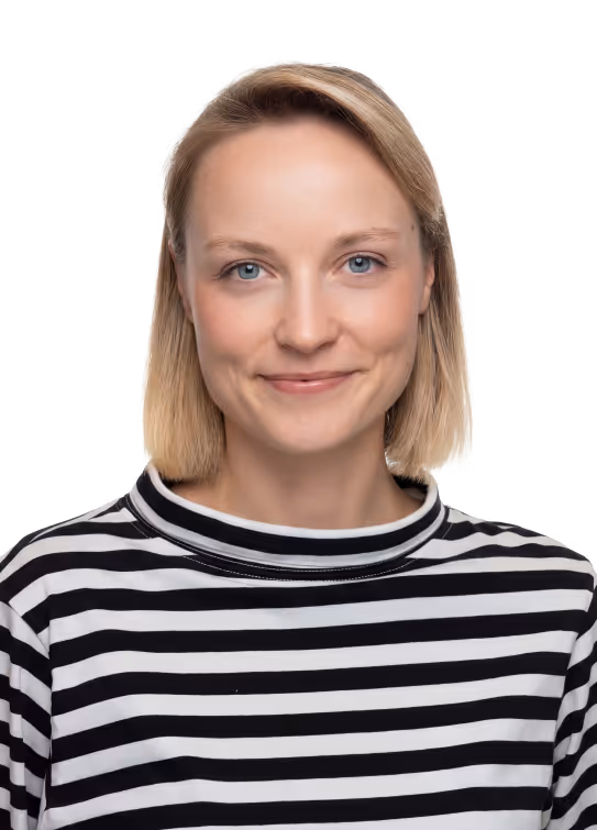 Smiling woman with short blonde hair wearing a black and white striped shirt.
