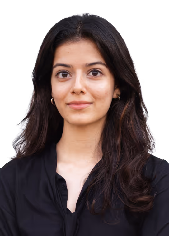 Young woman with long dark hair wearing a black top, looking confidently forward.