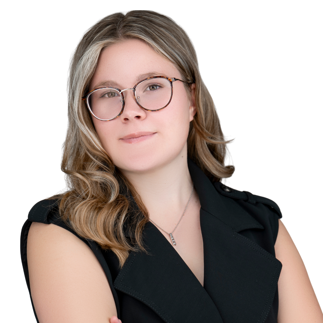 Smiling young woman with short brown hair and tortoiseshell glasses against a white background.