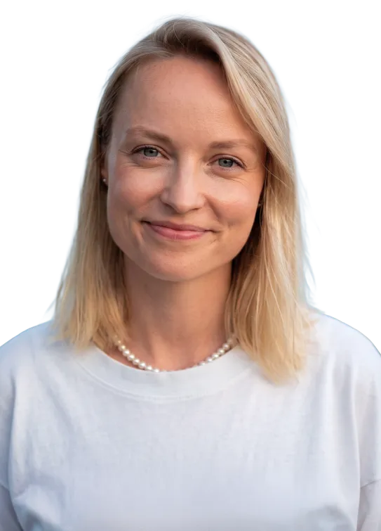Smiling woman with short blonde hair wearing a black and white striped shirt.