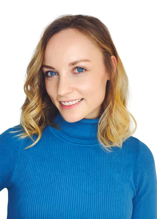 Smiling woman with short blonde hair wearing a black and white striped shirt.