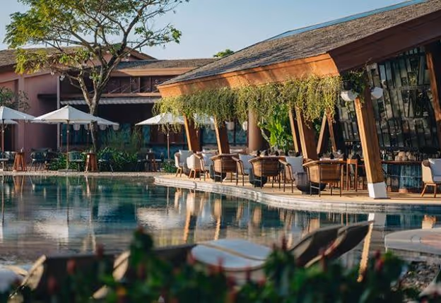 Chic and lively atmosphere at NOX Beach Club, with beachside seating and stylish decor under the night sky