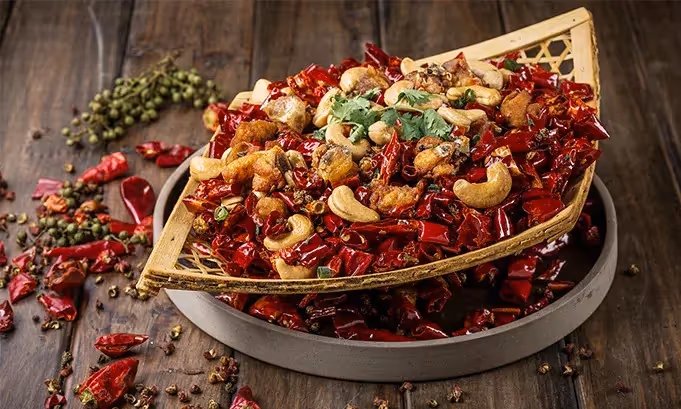 "Traditional Chinese restaurant in Hoi An with classic red lantern decor, round dining tables, and a menu featuring dim sum, Peking duck, and regional specialties."