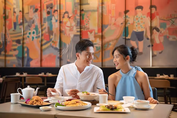 "Traditional Chinese restaurant in Hoi An with classic red lantern decor, round dining tables, and a menu featuring dim sum, Peking duck, and regional specialties."