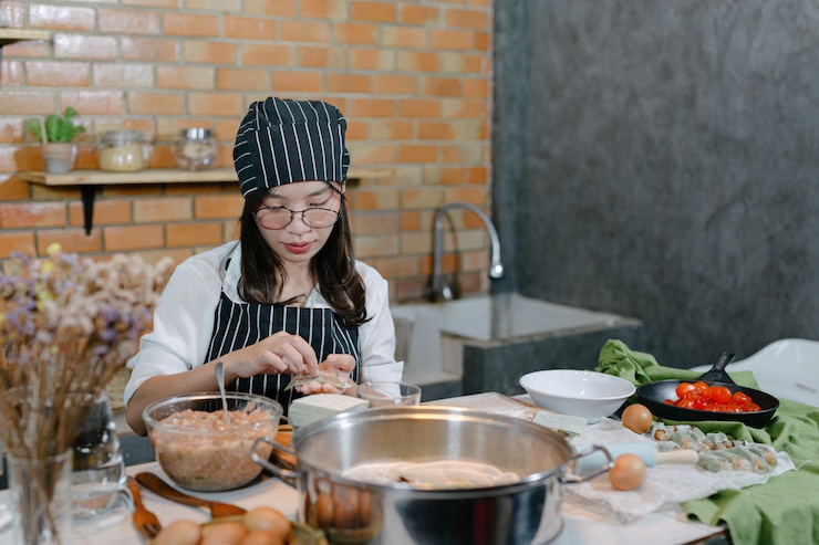 Woman wrapped in dumplings Asian food cook.