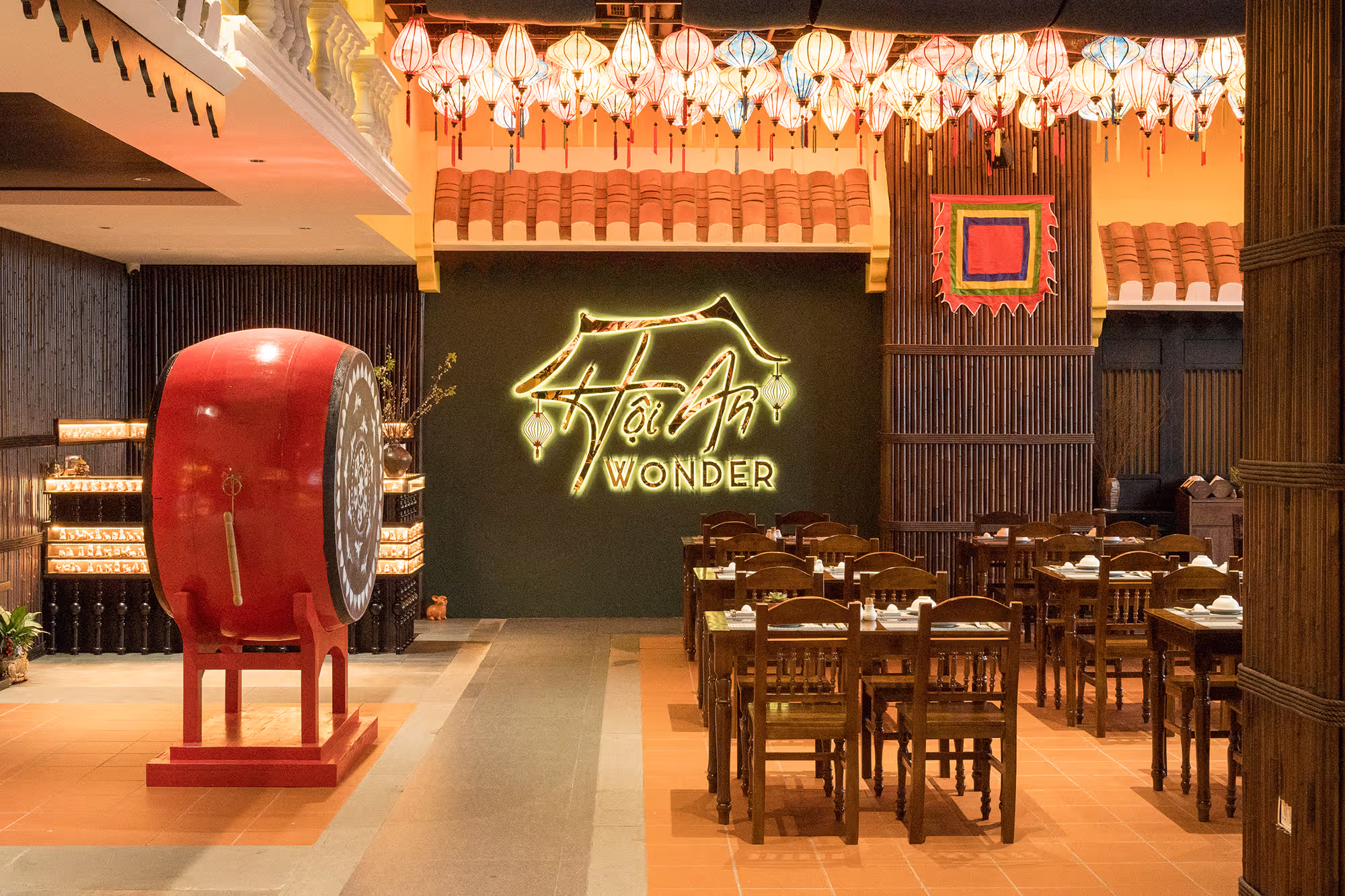 Hoi An Wonder restaurant at Hoiana featuring traditional Vietnamese decor with colorful lanterns, heritage roof tiles, and authentic local food ambiance.