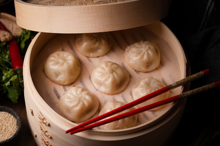 High angle of asian dumplings with chopsticks