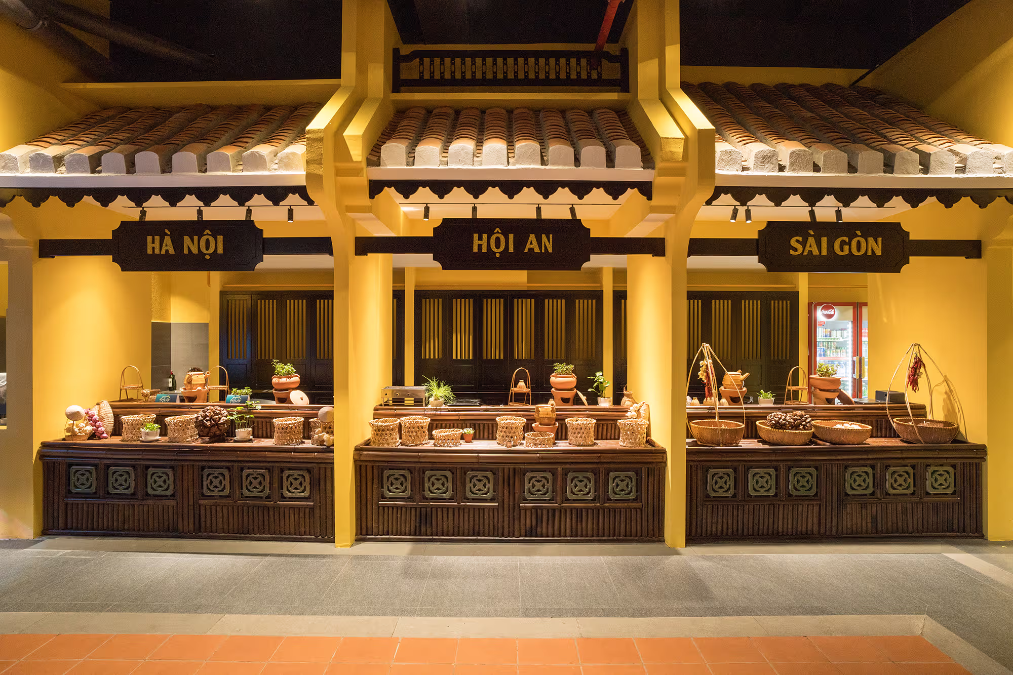 Traditional service counter framed by yellow walls, timber columns and heritage roof tiles