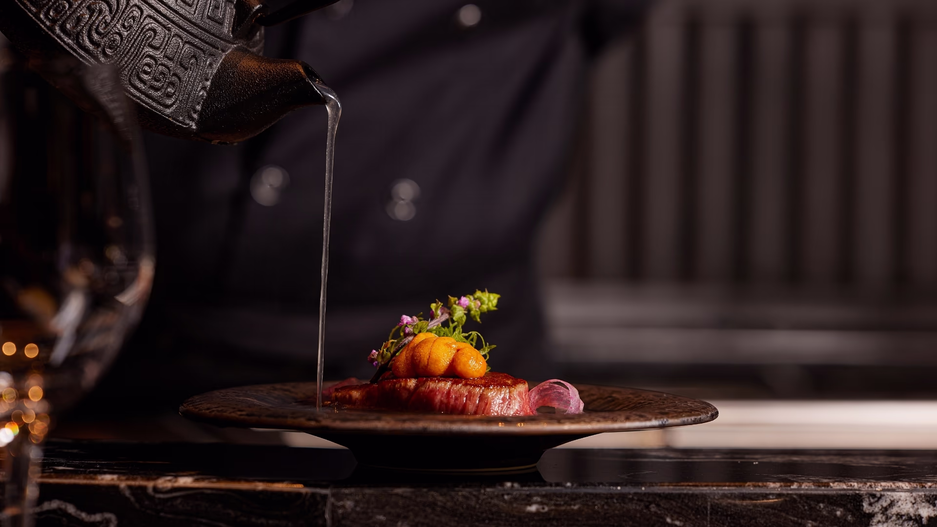 Chef searing carefully prepared ingredients on the teppanyaki grill