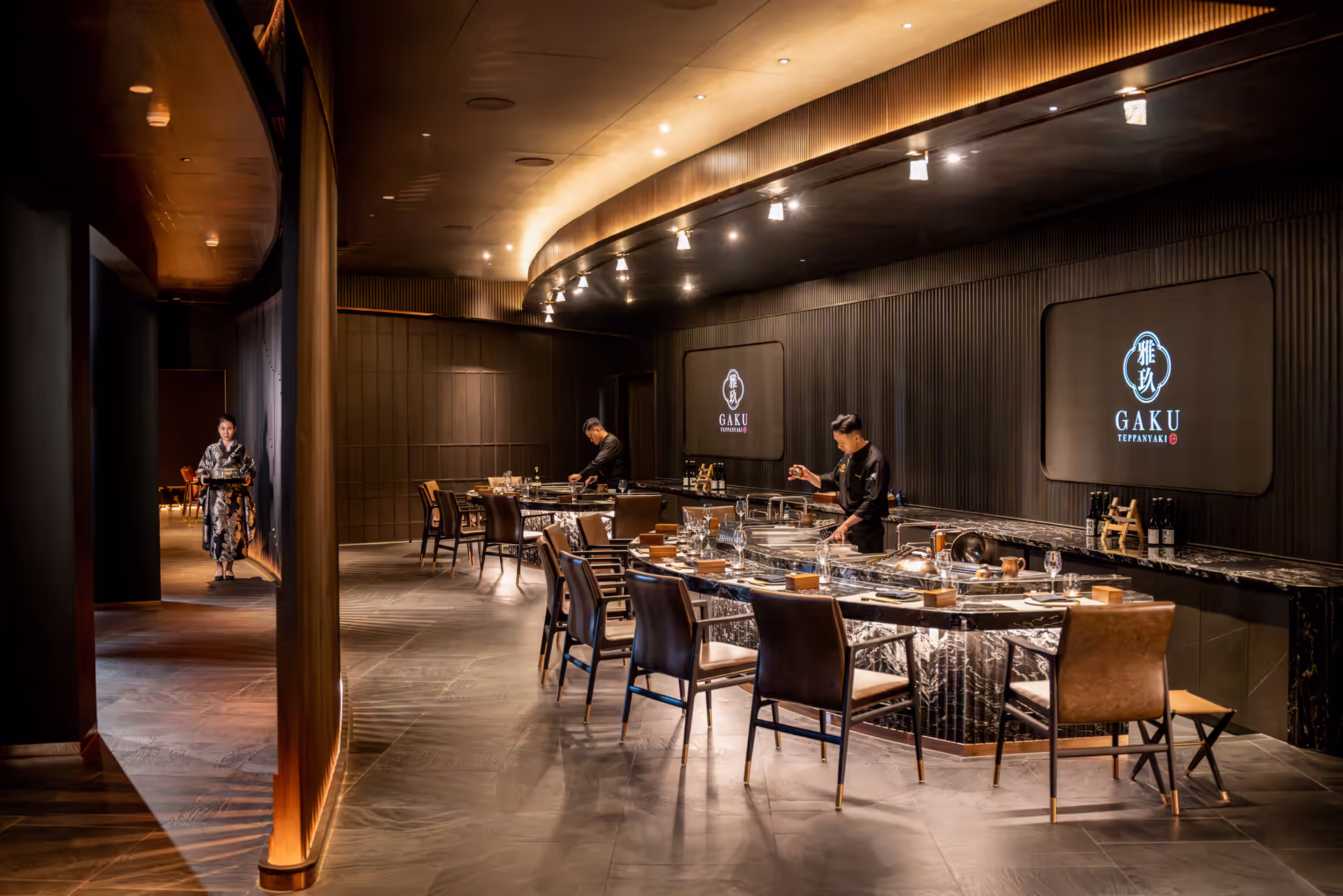 Contemporary Gaku Teppanyaki dining room with dark timber walls and sculptural lighting