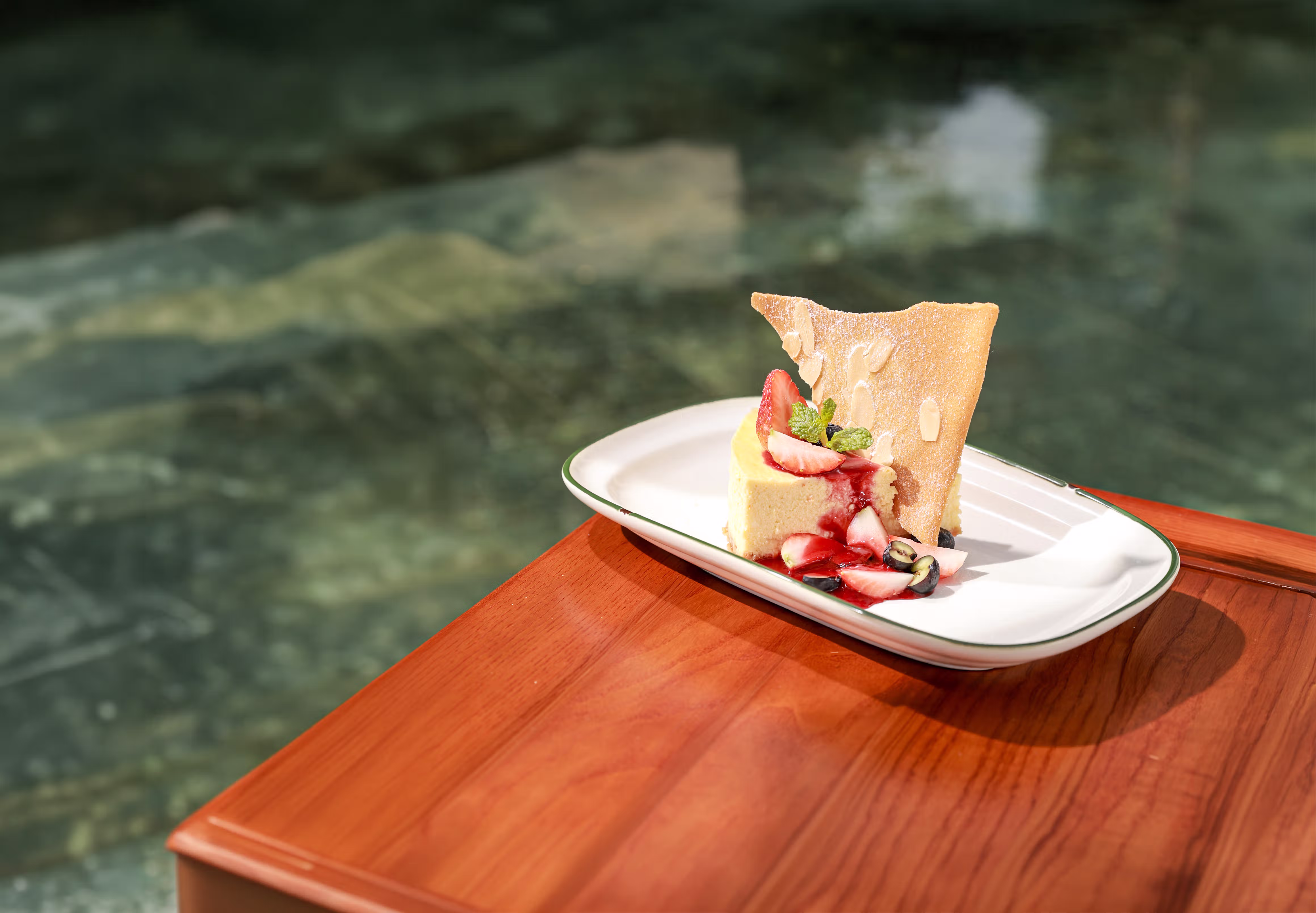 cheesecake with fresh strawberries and a crisp garnish brings a sweet finish to a sunlit afternoon