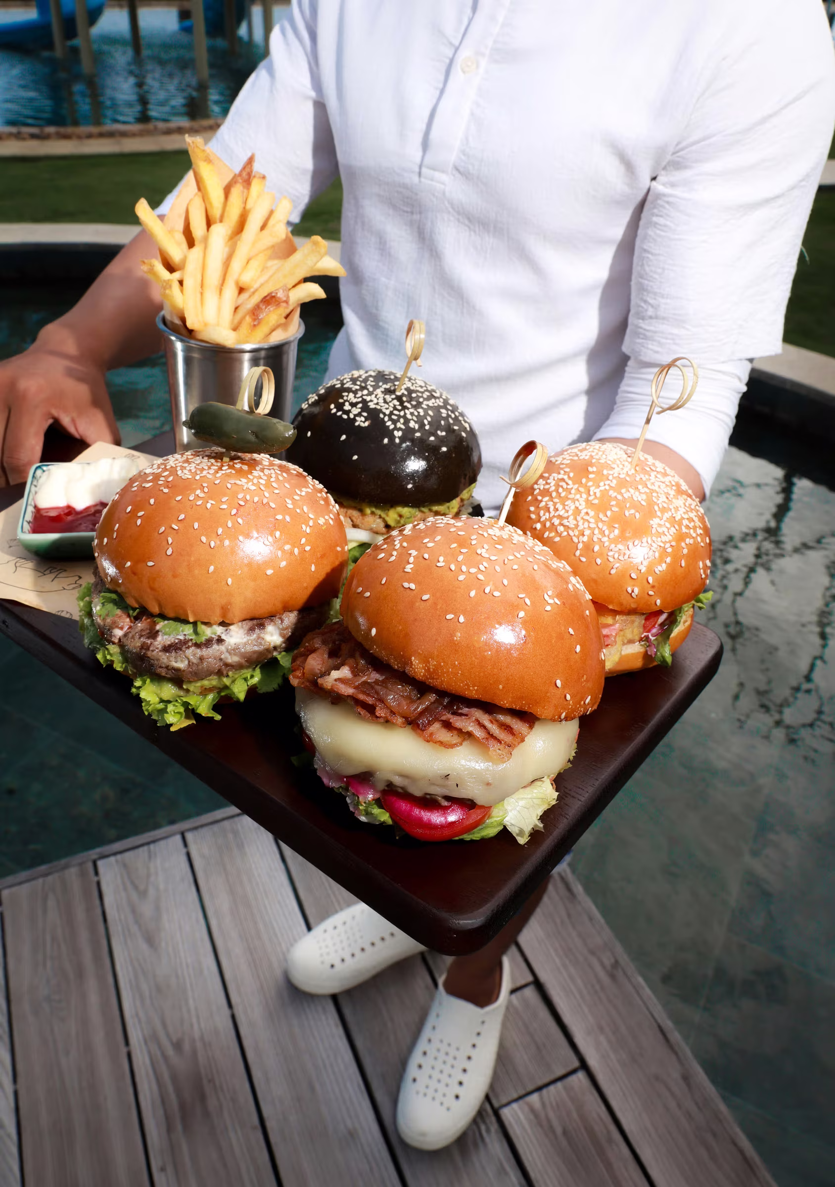 A generous tray of brioche sliders and golden fries arrives ready to share by the pool