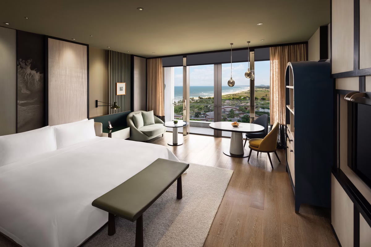 Premier Ocean View King opening onto a private coastal-view balcony at New World Hoiana Beach Resort