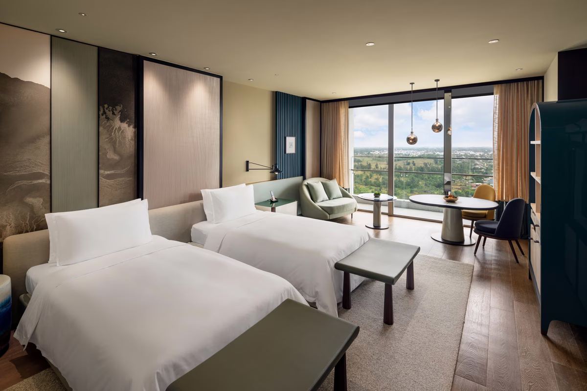 Deluxe Ocean View Twin room with twin beds and a private ocean-view balcony at New World Hoiana Beach Resort