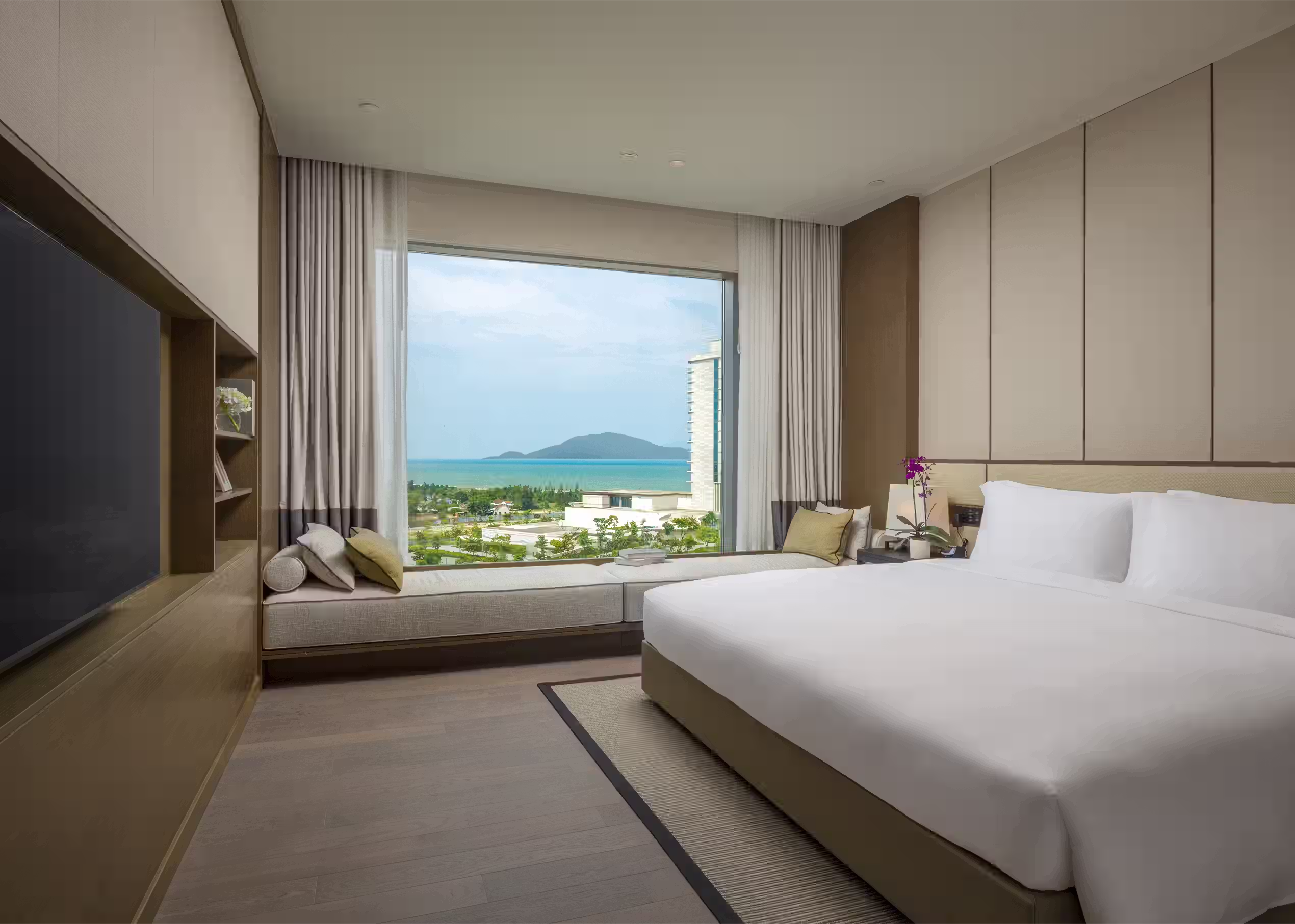 Primary king bedroom with panoramic coastal views in the Three-Bedroom Residence at Hoiana Residences