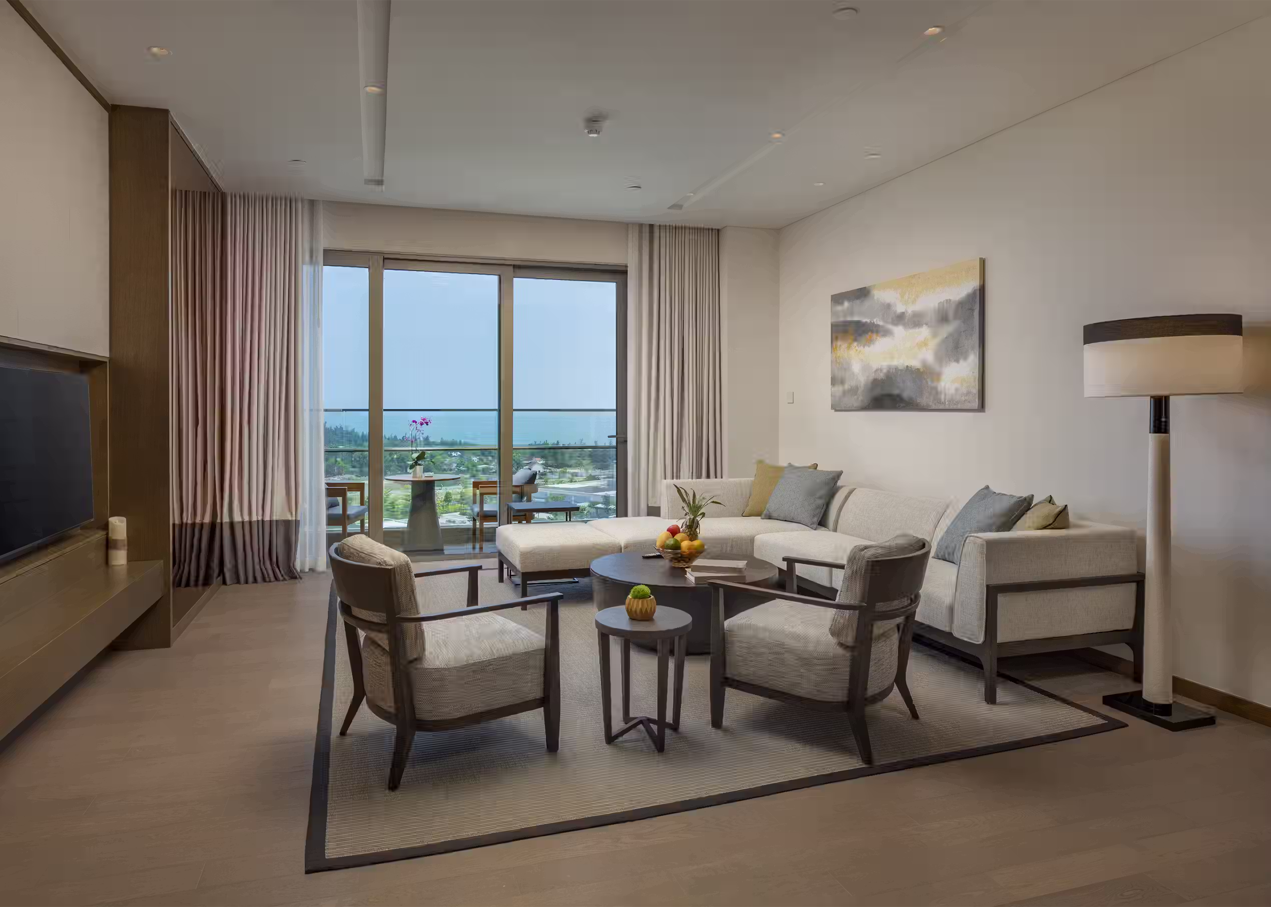 Open-plan living and dining area with a daybed sofa and balcony access in the Three-Bedroom Residence at Hoiana Residences