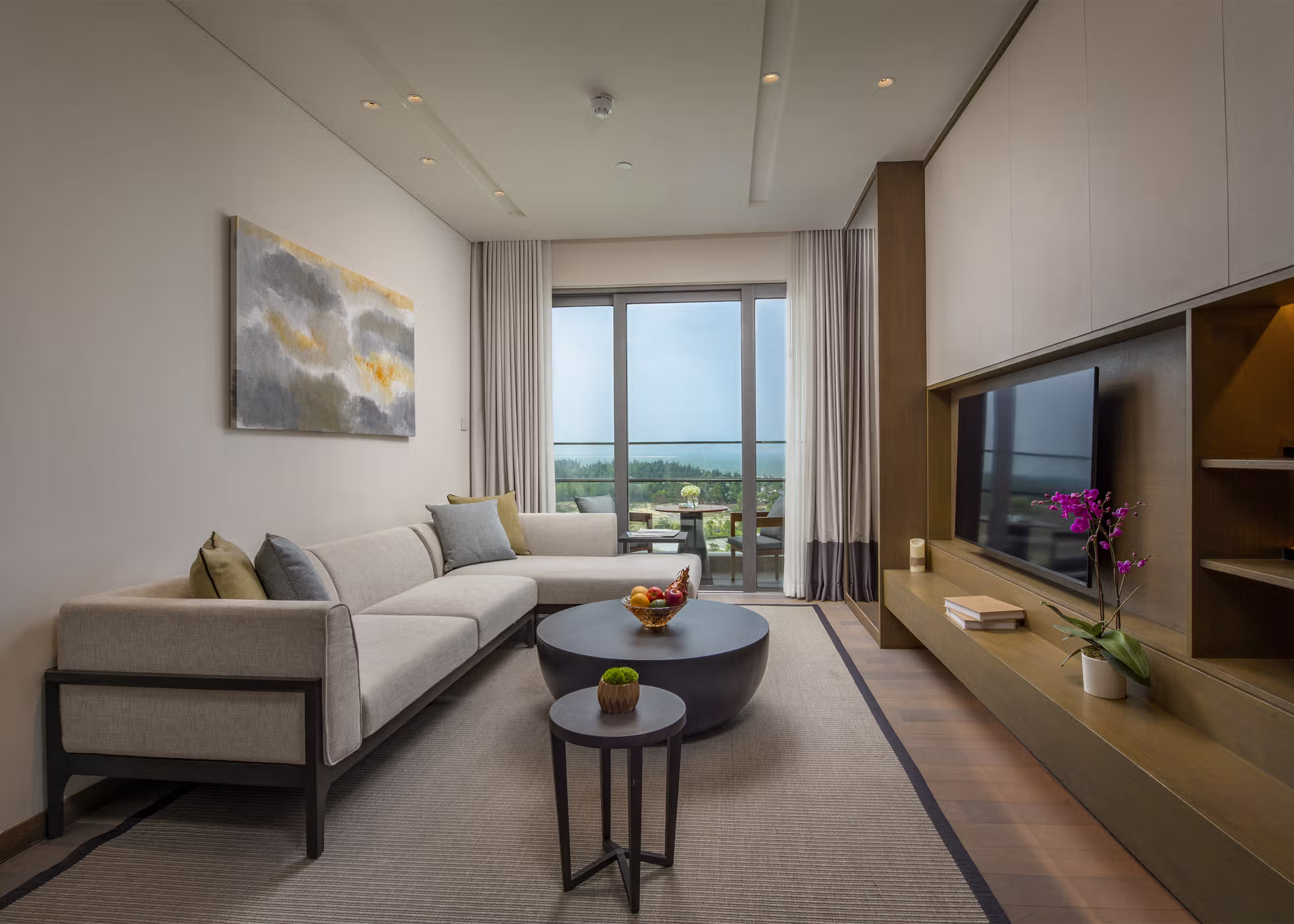 Natural light fills the living room and balcony area of the One-Bedroom Twin Residence at Hoiana Residences