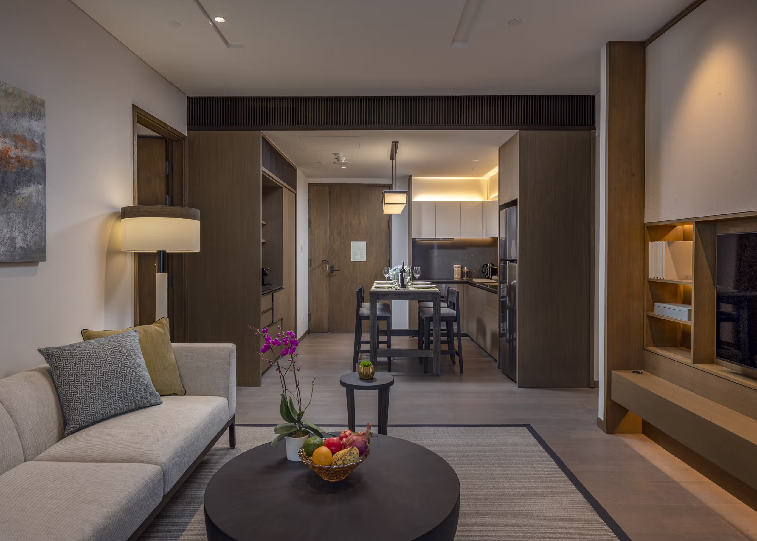 Open-plan living room flowing into the kitchen and dining space in the One-Bedroom Twin Residence at Hoiana Residences