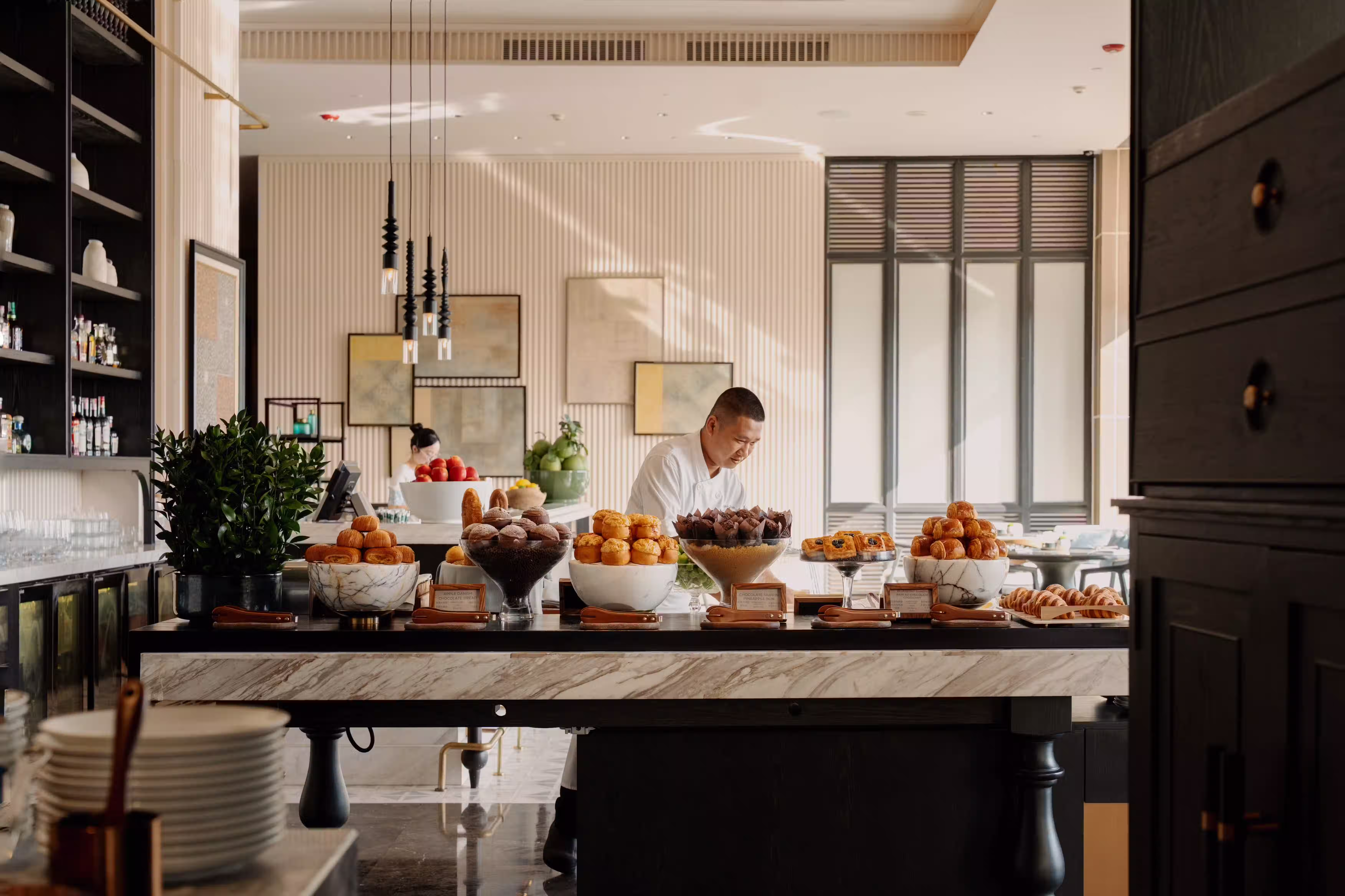 Breakfast buffet arranged with fresh fruit, pastries and morning favourites