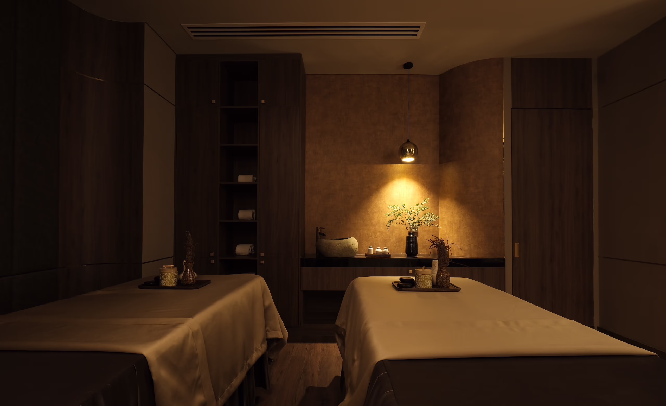 Warmly lit entrance to Tinh Spa at Hoiana Resort & Golf, framed by metallic curtains, natural stone and rich wood finishes.