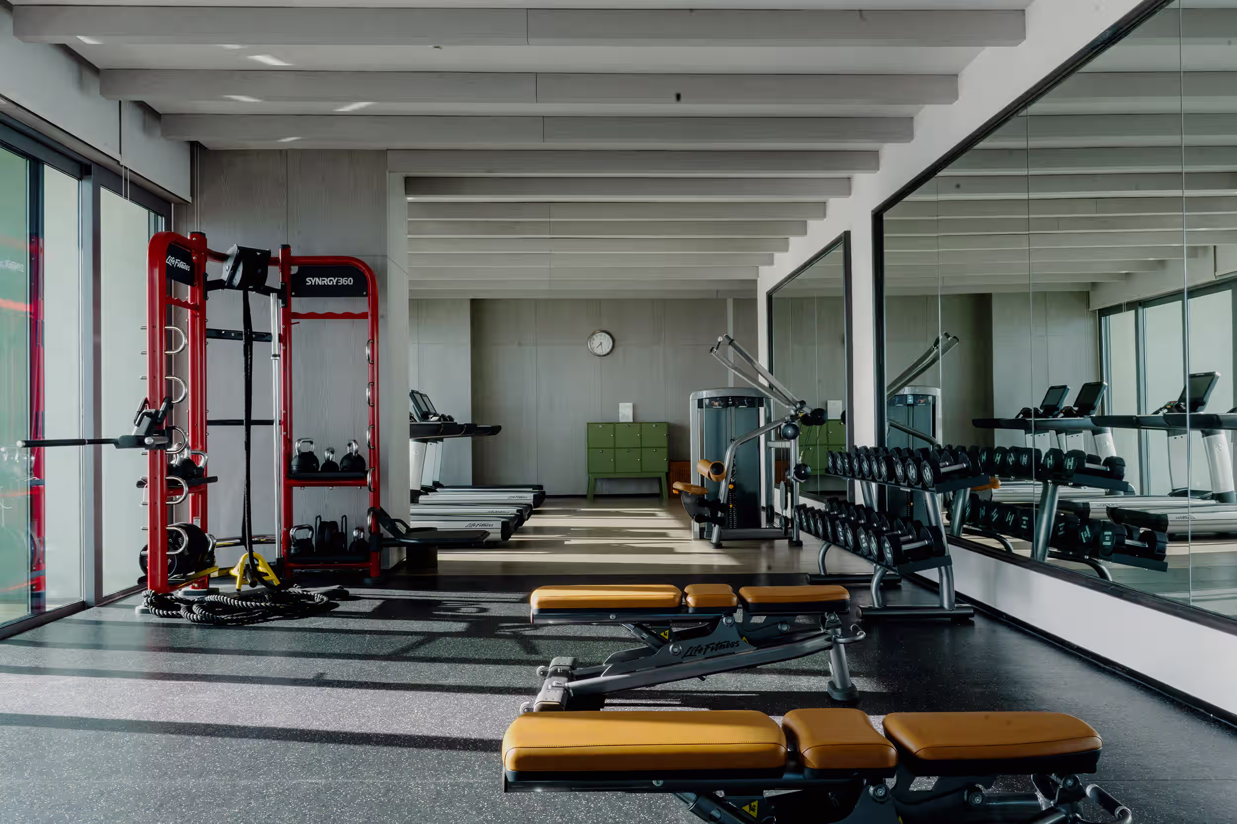 Ocean-view fitness centre at Hoiana Resort & Golf, equipped with treadmills, a rowing machine, free weights and strength-training stations.