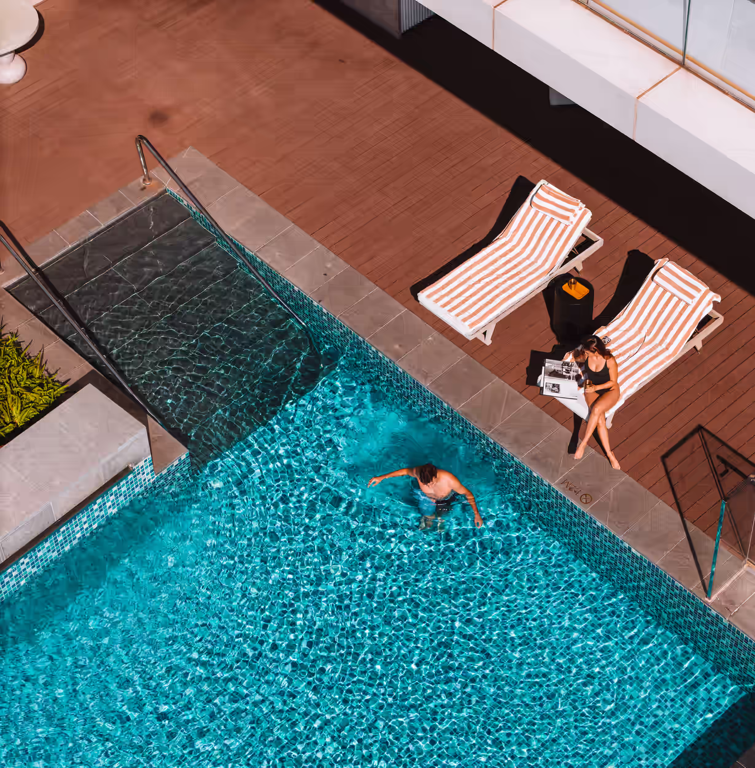 Top-down view of the infinity pool and sun deck at Hoiana Hotel & Suites.
