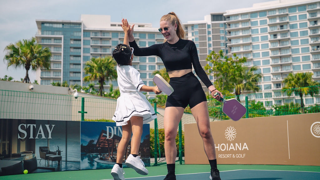 Guests celebrating a point during a lively pickleball game at Hoiana Resort & Golf.