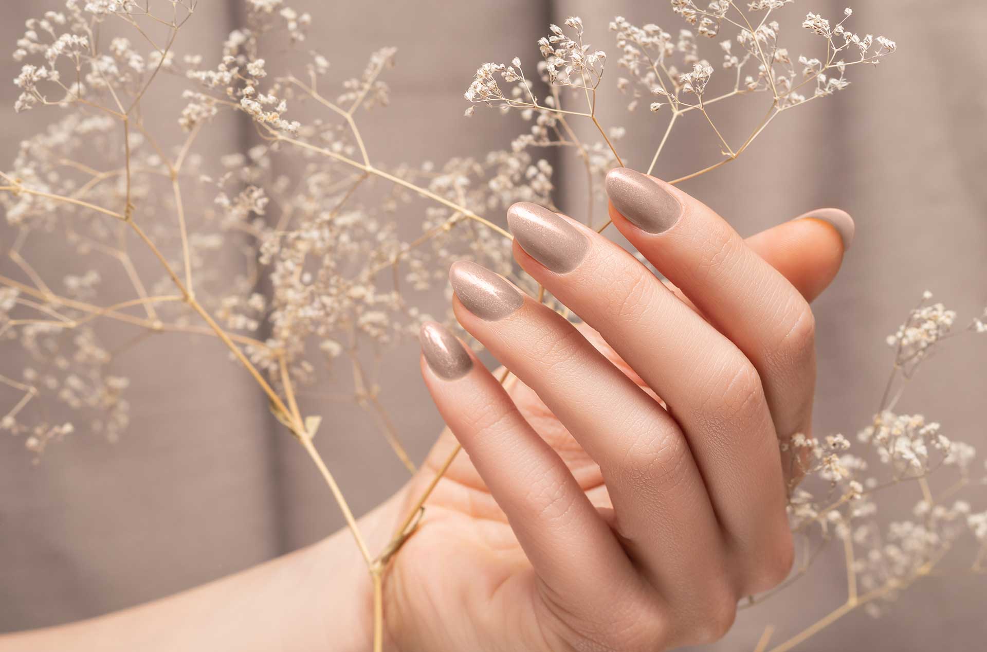 Beige manicure round tips against a soft background.