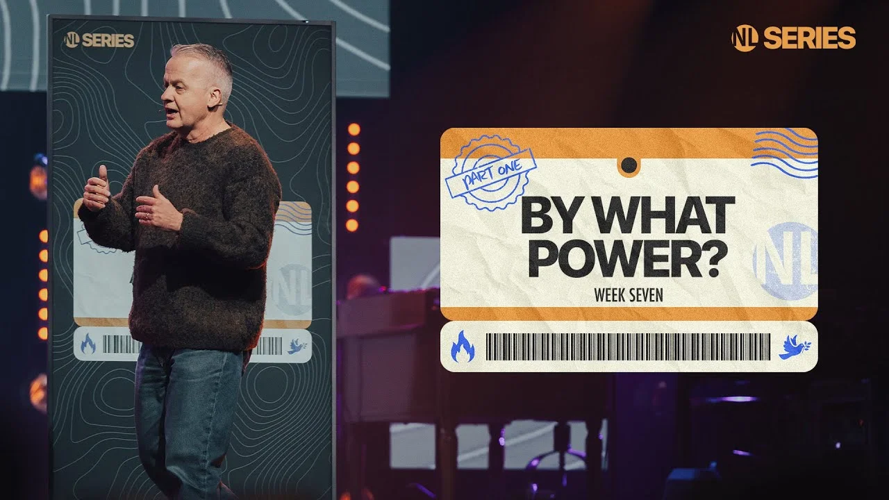 Pastor speaking on stage beside a screen reading "By What Power? Week Seven, Part One" from NL Series.