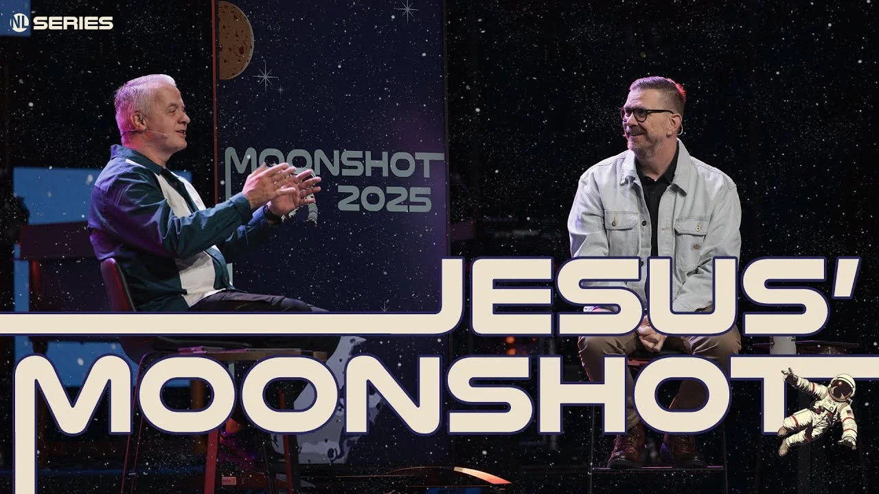 Two men seated on stage discussing "Jesus' Moonshot" with a 2025 mission theme in a starry space backdrop.