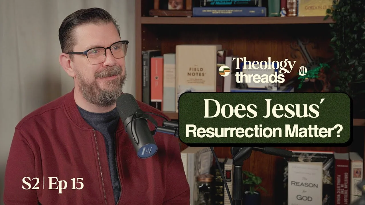 Theologian discussing Jesus' resurrection in a podcast studio.