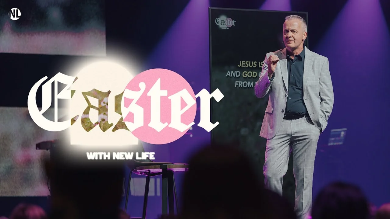 A pastor in a gray suit preaches on stage under purple lighting with large Easter text overlay that reads "Easter With New Life."