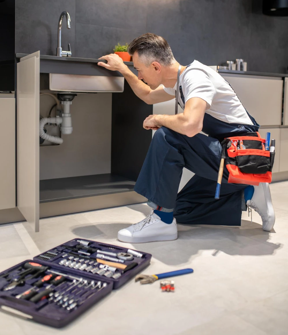 Professional plumber performing pipe repair services, fixing a damaged water pipe to restore proper flow and prevent leaks.