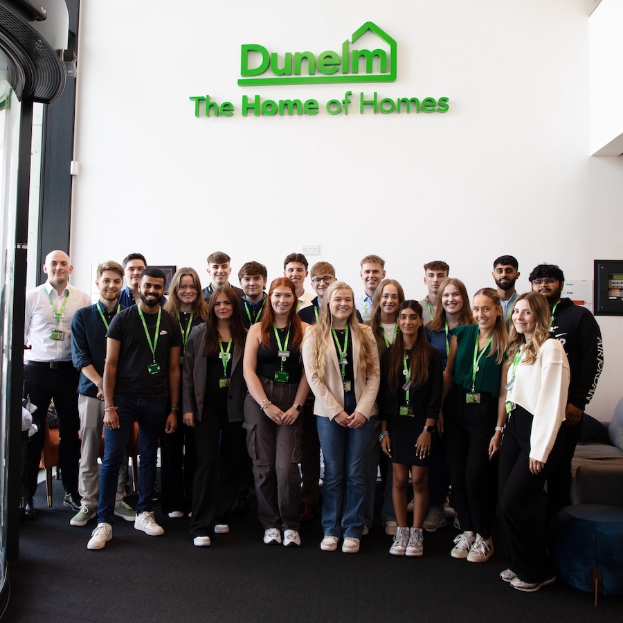 A group of Dunelm workers standing together and smiling. 