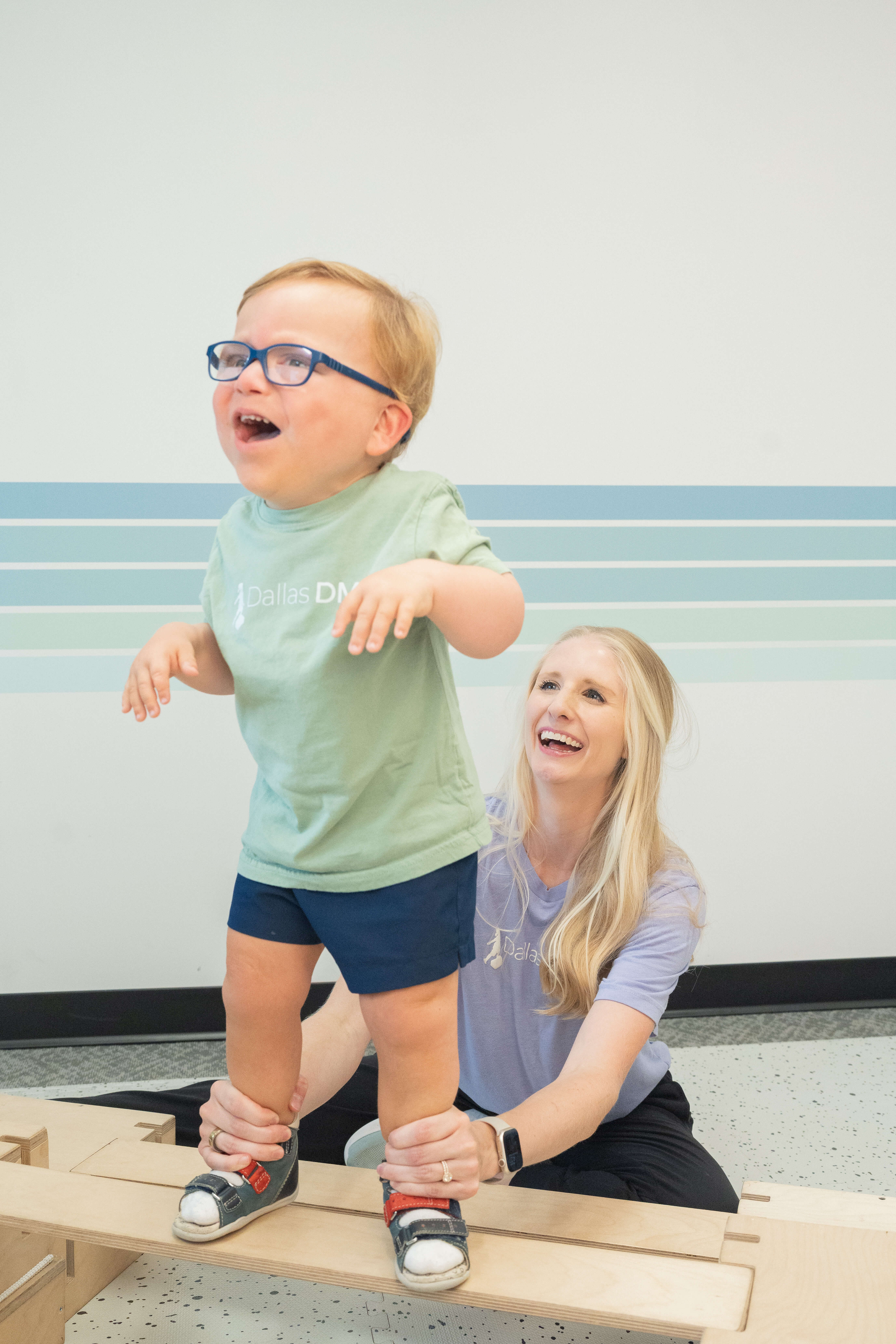 Pediatric physical therapist working with infant during DMI therapy session in Richardson, TX