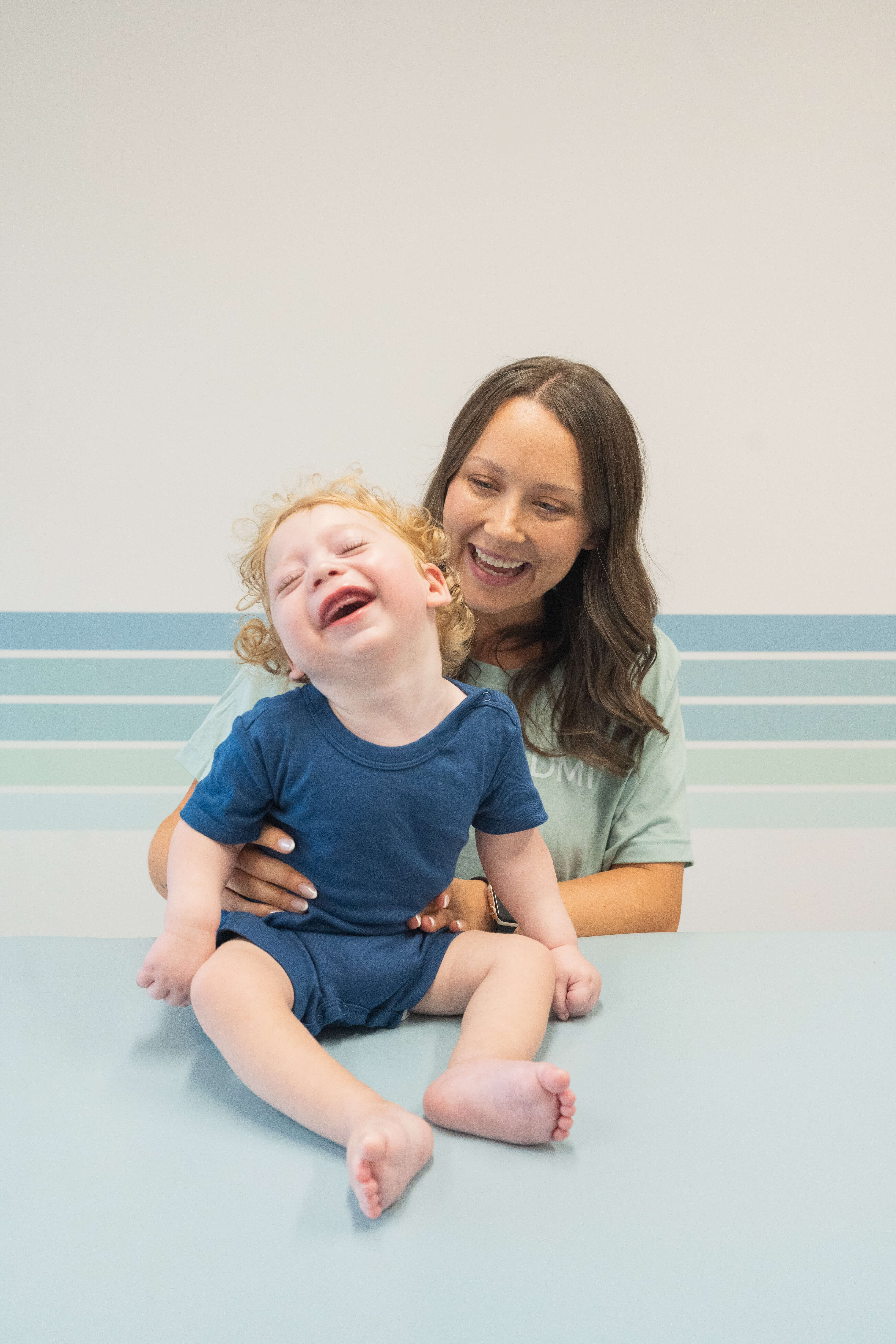 Dallas DMI pediatric physical therapist working with child during Richardson area intensive therapy session