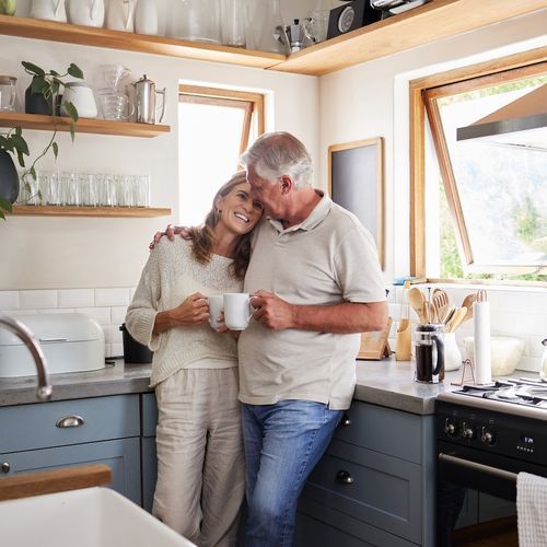 Couple embracing in a bright modern kitchen