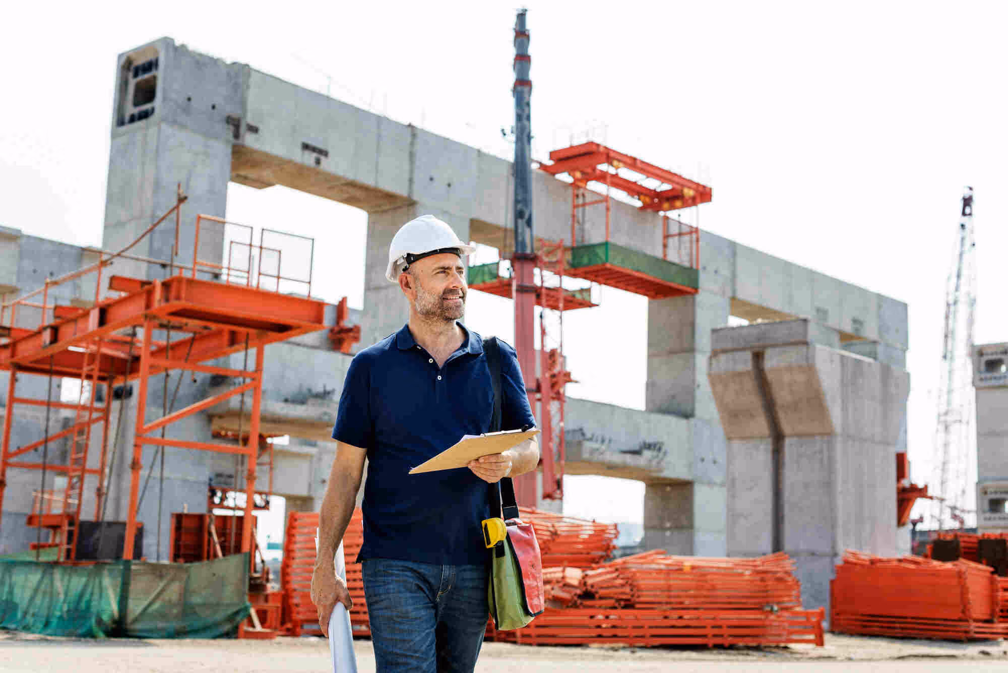 Business consultant reviewing documents at a shipping yard.