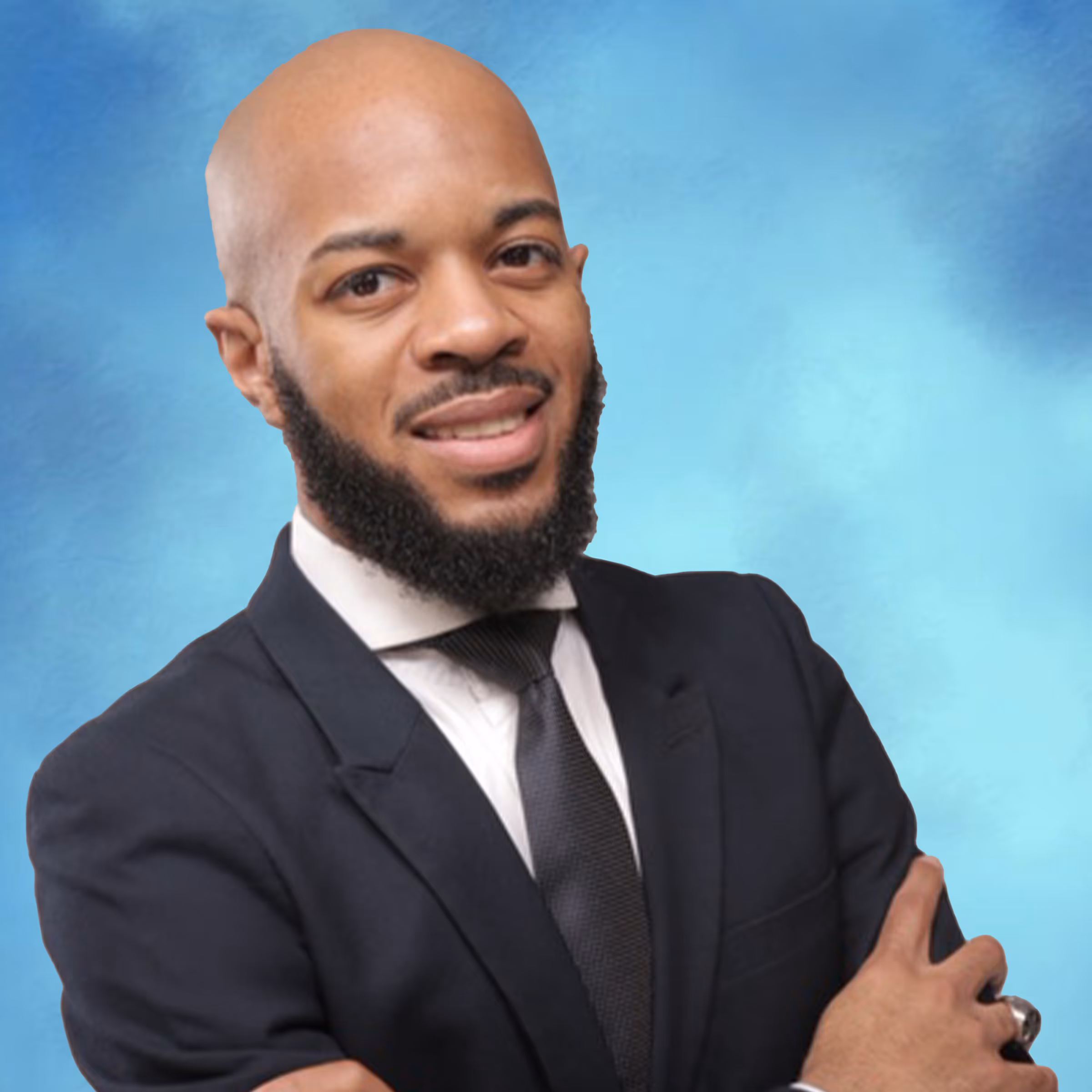 Professional headshot of a man smiling in front of a blue background
