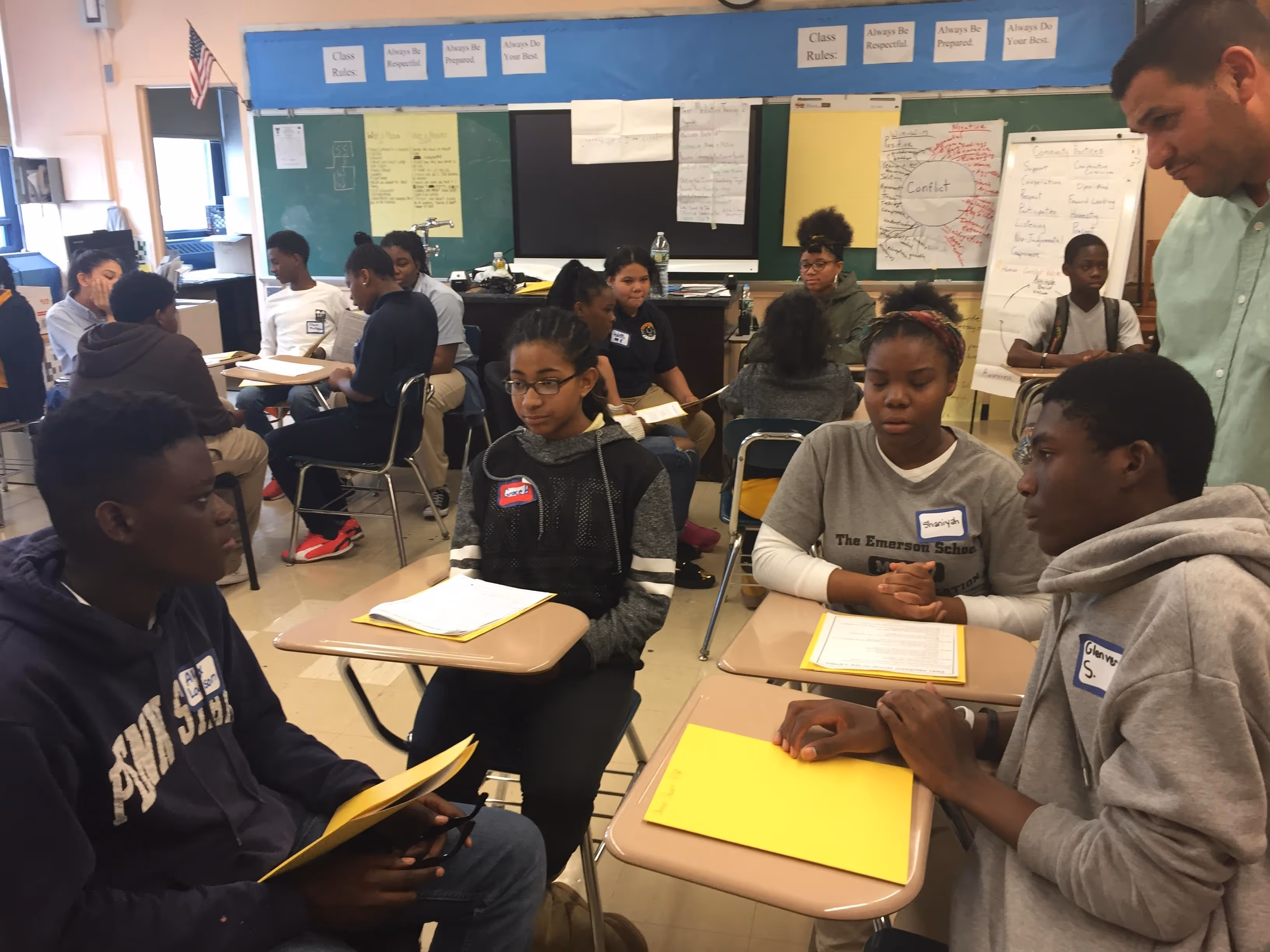 Students seated in groups working together in a classroom