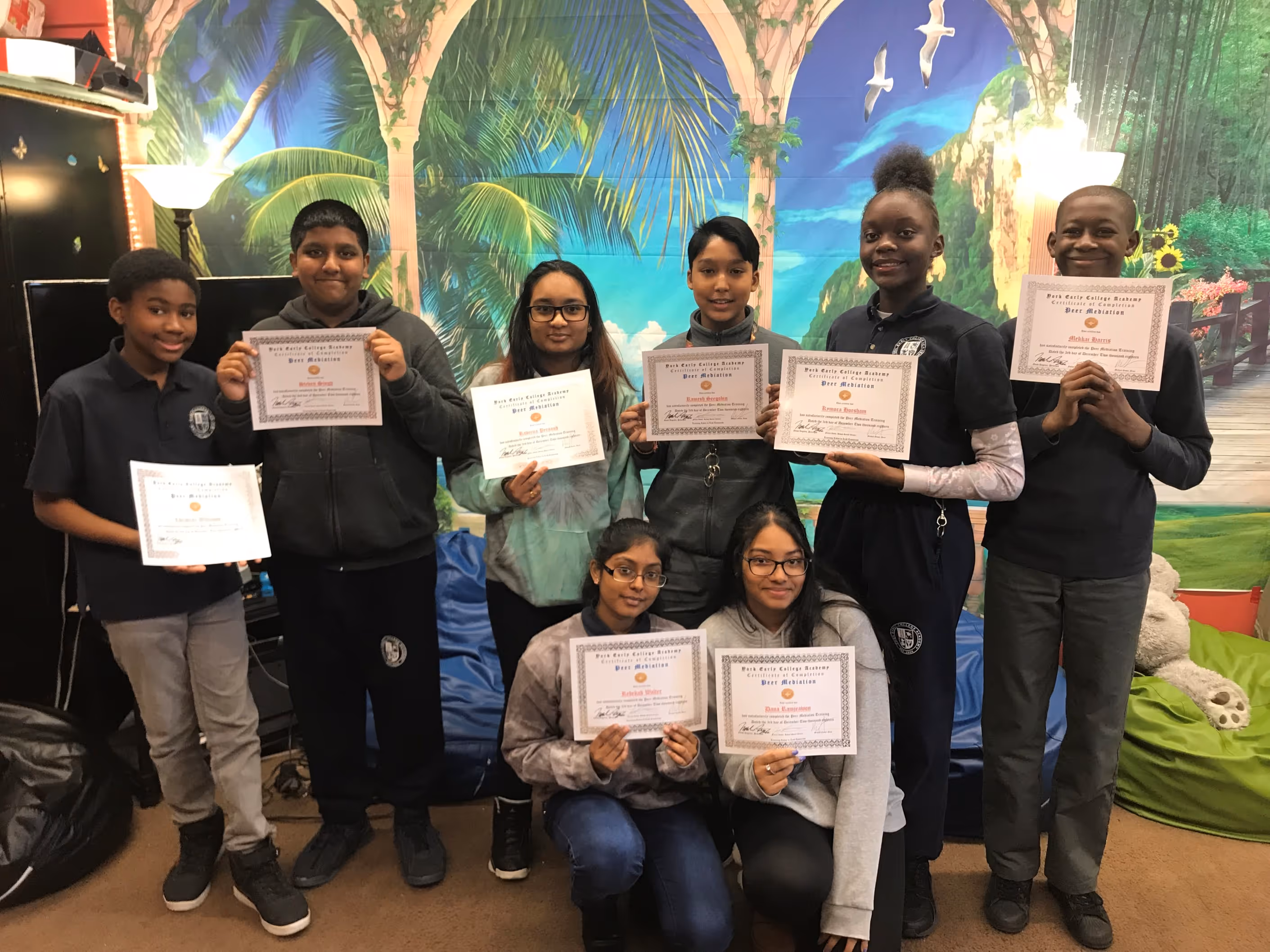 Group of students holding certificates and smiling for a photo