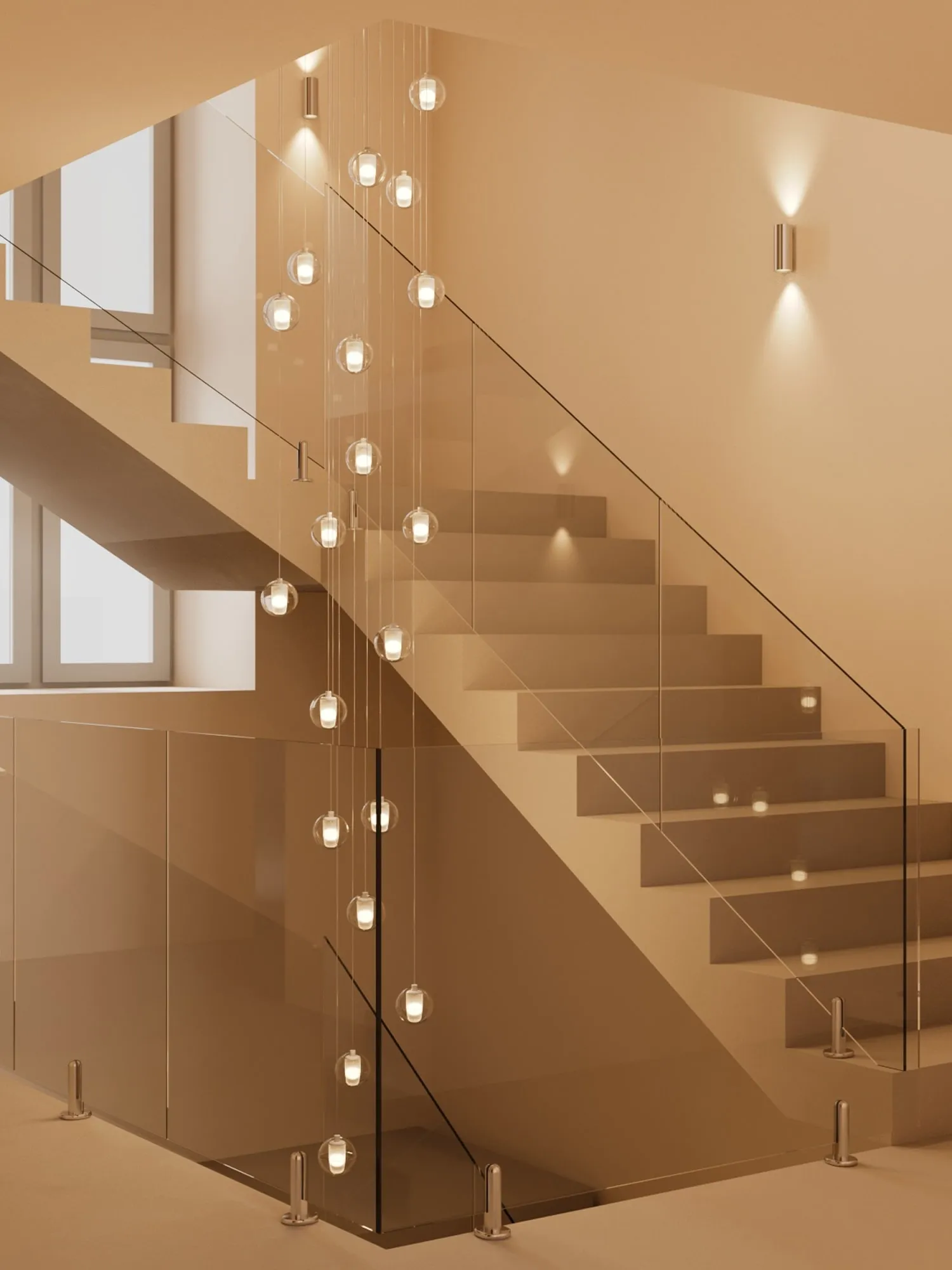 Modern staircase with glass railings and hanging spherical pendant lights in a warm beige interior.