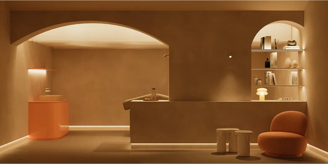 Minimalist spa reception area with beige walls, an archway, a coral sink cabinet, illuminated built-in shelves, a coral armchair, and two small stools.