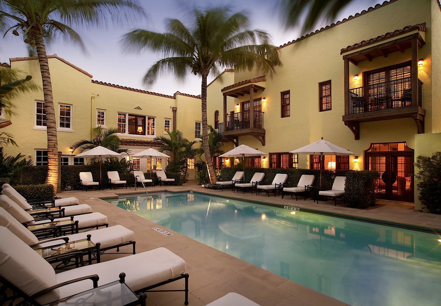 The Brazilian Court Hotel pool with rooms and balconies surrounding.